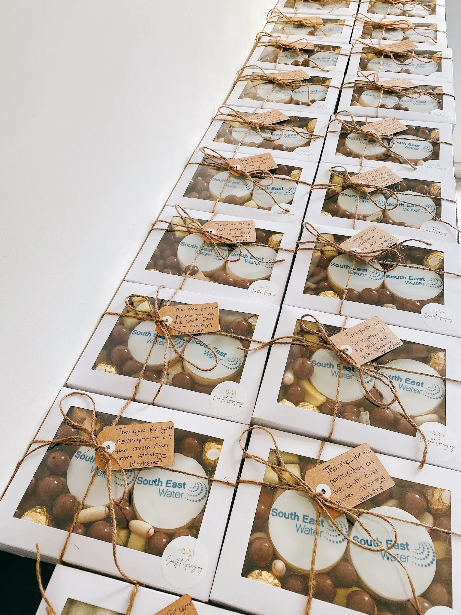 Row of white Coastal Grazing gift boxes branded for South East Water corporate order